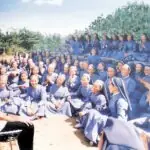 Sisters of Mary in Korea seated outdoors during a group gathering with Father Al.