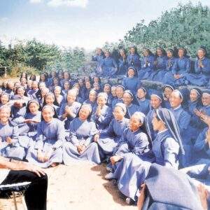 Sisters of Mary in Korea seated outdoors during a group gathering with Father Al.
