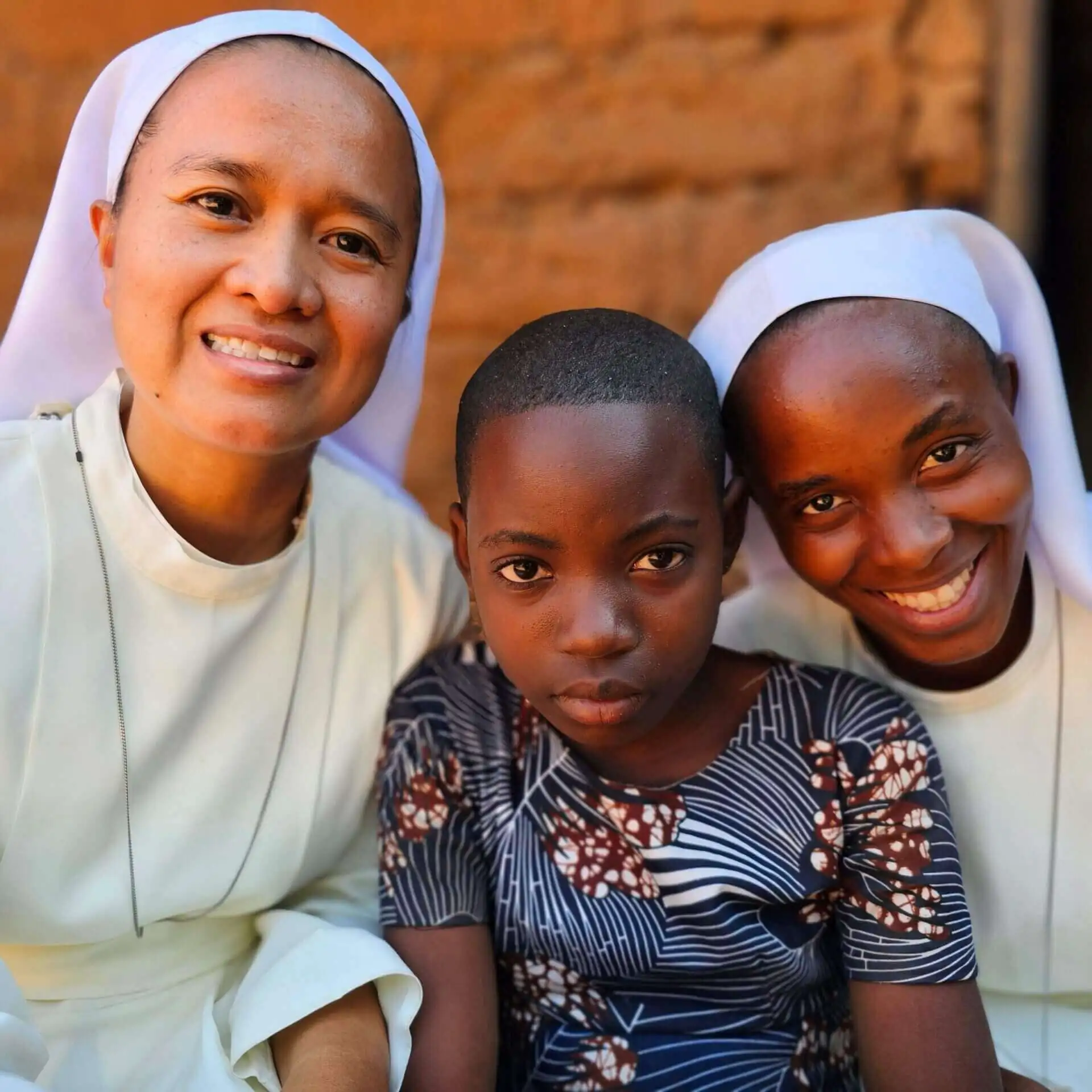 Two Sisters of Mary with a girl in poverty in Tanzania