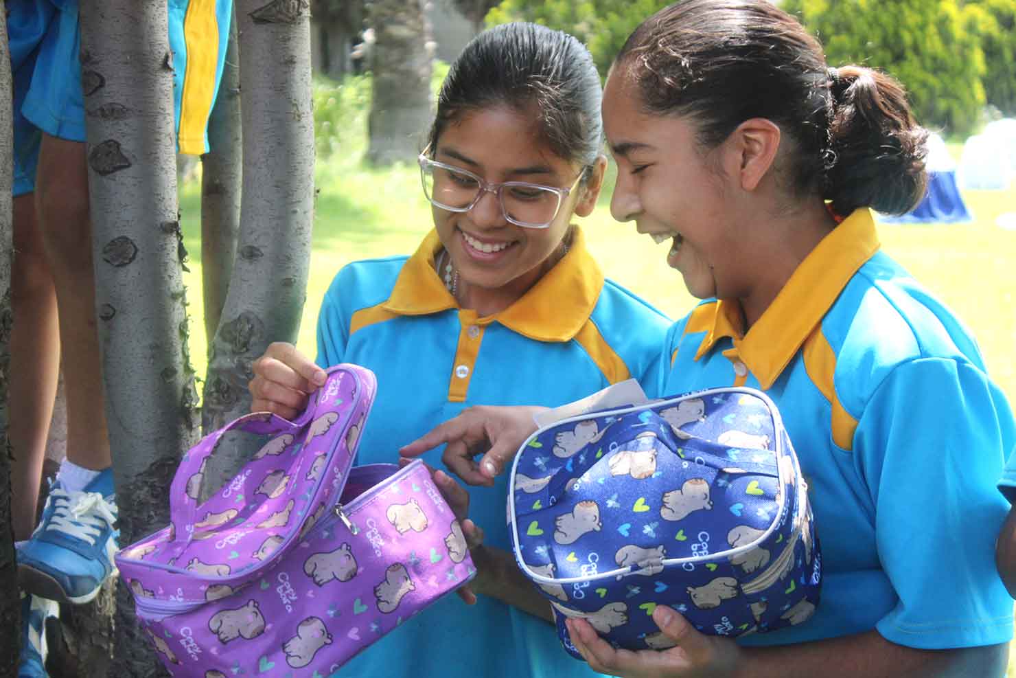 Two Chalco Girlstown students smile as they open their birthday gifts during the Every Child’s Birthday celebration.