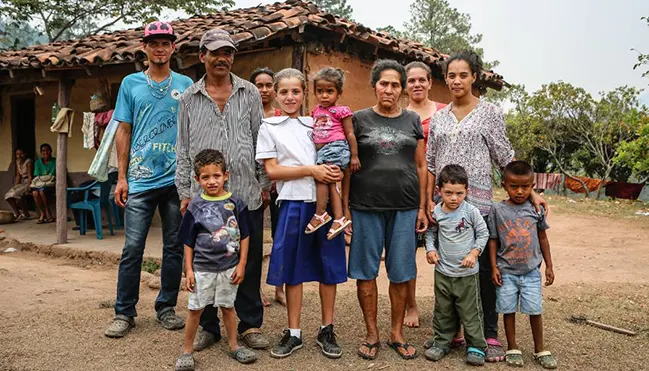 Sisters-of-Mary-World-Villages-for-Children-Family-Mexico A student from the Sisters of Mary stands with her family outside their home in rural Mexico.